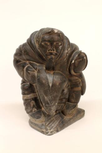 Seated Figure with Seal, c. 1960
Inuit; Canada
Soapstone (Steatite); 14 x 10 x 8 in. 
2012.2…