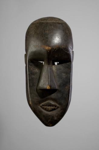 Poro Society Mask, 20th Century
Mende people; Ivory Coast
Wood; 24 5/8 x 10 3/4 x 11 3/4 in.
…