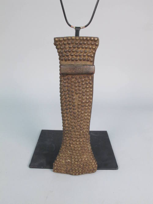 Sheath Currency, 19th Century
Kundu culture; Democratic Republic of the Congo
Brass and wood;…