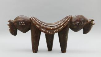 Headrest, early 20th Century
Dinka culture; South Sudan
Wood and metal; 12 × 26 3/4 × 5 in.
…