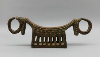 Headrest, early 20th Century
Dinka culture; South Sudan
Wood and metal; 8 1/4 × 24 × 4 1/2 in…