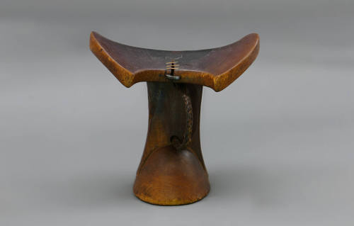 Headrest, early to mid 20th Century
Turkana culture; Kenya
Wood, leather and metal; 7 3/4 × 8…