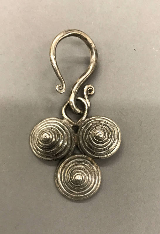 Earring, 20th Century
Miao culture; probably Guizhou Province, China
Silver; 2 × 3 3/4 in.
2…