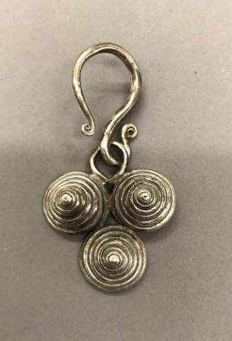 Earring, 20th Century
Miao culture; probably Guizhou Province, China
Silver; 2 × 3 3/4 in.
2…