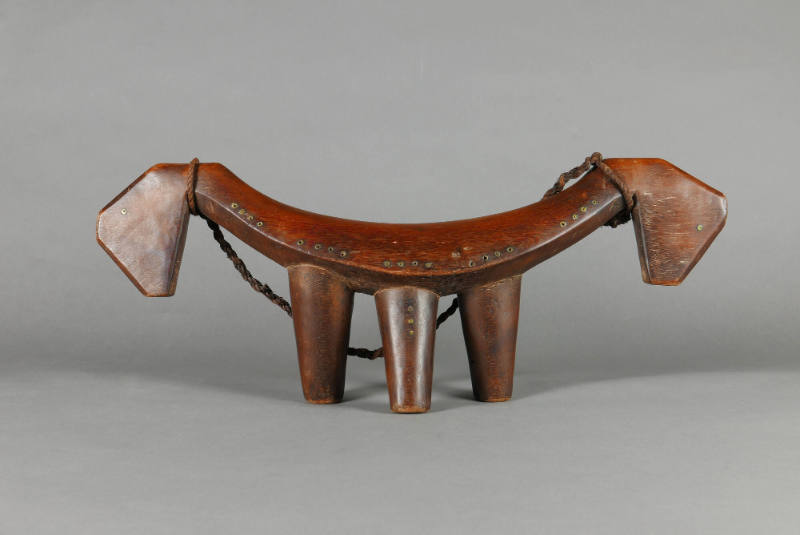 Headrest, 20th Century
Dinka culture; South Sudan
Wood, metal and leather; 9 1/2 × 24 1/2 × 4…