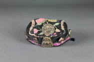 Hat with Budai Design, early 20th Century
Maker Unknown; China
Silk, cotton and metal; 2 1/2 …