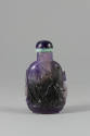 Carved Purple Snuff Bottle, early 20th century
China
Fluorite and jade; 3 1/8 × 1 7/8 × 1 1/4…