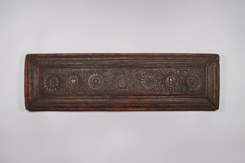 Sutra Cover, 19th Century
Tibet Autonomous Region
Wood; 8 3/4 × 29 3/4 × 1 7/8 in.
2021.8.32…