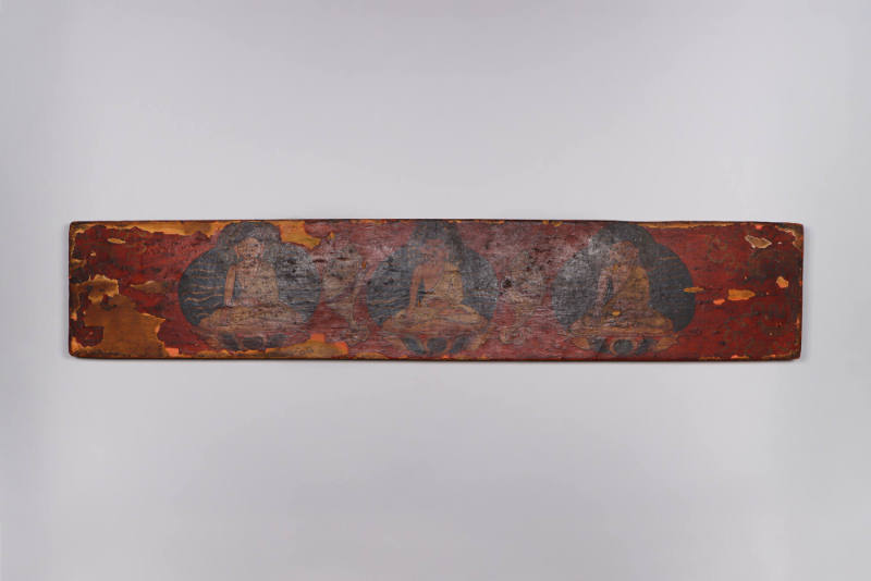 Sutra Cover, 19th Century
Tibet Autonomous Region
Wood and paint; 4 3/4 × 23 5/8 × 7/8 in.
2…
