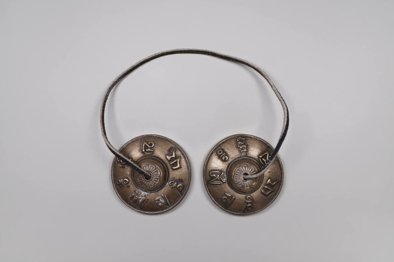 Prayer Cymbals (Ting-shags), 20th Century
Tibet Autonomous Region
Silver and leather; 1 × 2 1…